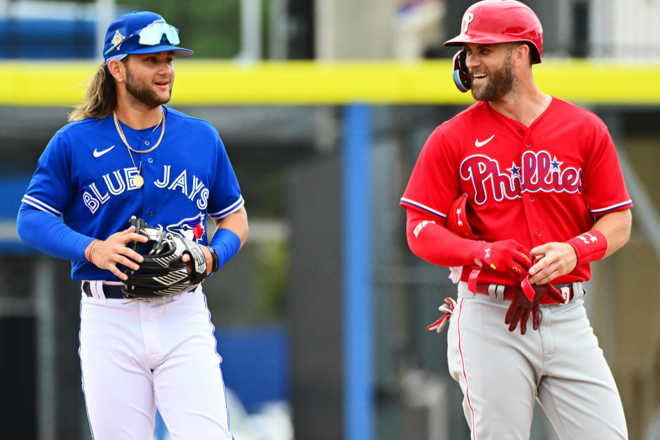 In an MLB spring training game Bo Bichette of the Blue Jays talks to last year's NL MVP winner, Bryce Harper of the Philadelphia Phillies. (Photo by Julio Aguilar/Getty Images)