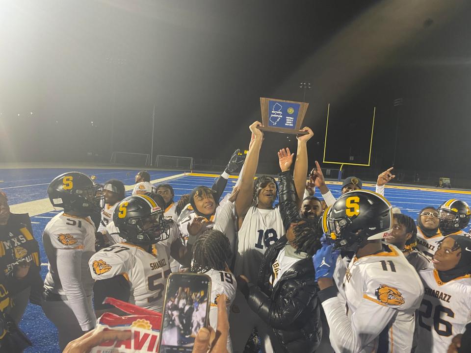 Shabazz players celebrate the North 2, Group 1 sectional title after a 40-13 win over Butler.