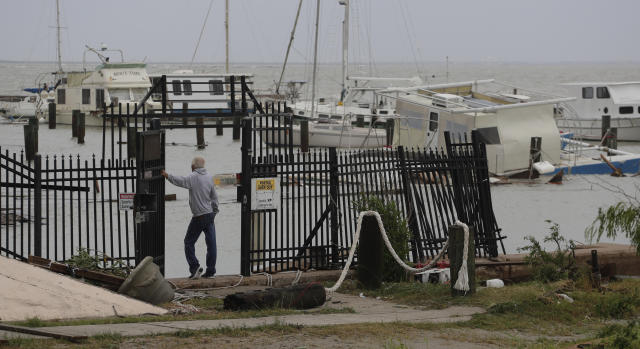 Myrle Tucker surveys the marina where is was rescued over night after his boat was damaged and sunk after it was hit by Hurricane Hanna, Sunday, July 26, 2020, in Corpus Christi,Texas. Tucker's boat and about 30 others were lost or damaged in the storm. (AP Photo/Eric Gay)
