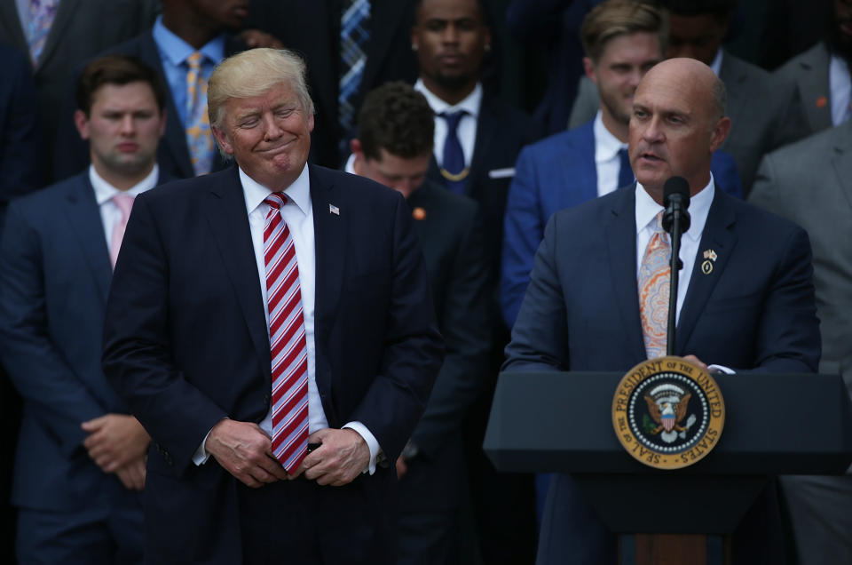 Clemson University President Jim Clements (R) speaks as President Donald Trump (L) listens when the Tigers visited after winning the national title in 2017 (Getty Images)
