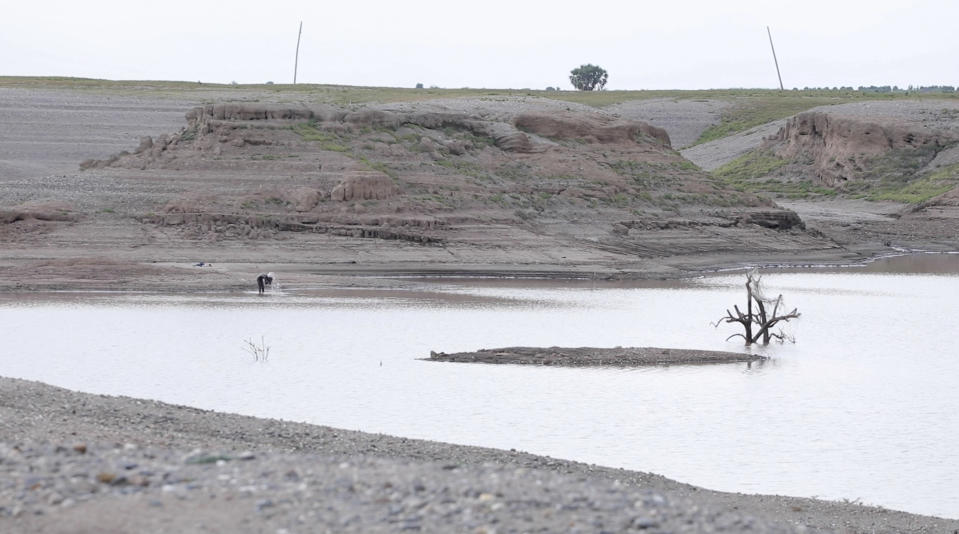 In this photo taken from a video shot on Wednesday, Aug. 4, 2021 in Wad el-Hilu, Sudan, a man washes in the Setit river, known in Ethiopia as Tekeze River. Locals and refugees have pulled dozens from bodies from the river separating Ethiopia’s troubled Tigray region from Sudan in the past week, many with bullet wounds and their hands bound. Witnesses say that they are ethnic killings committed by Ethiopian government forces of Tigrayans, and that the bodies are being dumped to conceal the evidence. There was no immediate comment from the Ethiopian government but it has denied ethnic killings in the past. (AP Photo/Mohaned Awad)