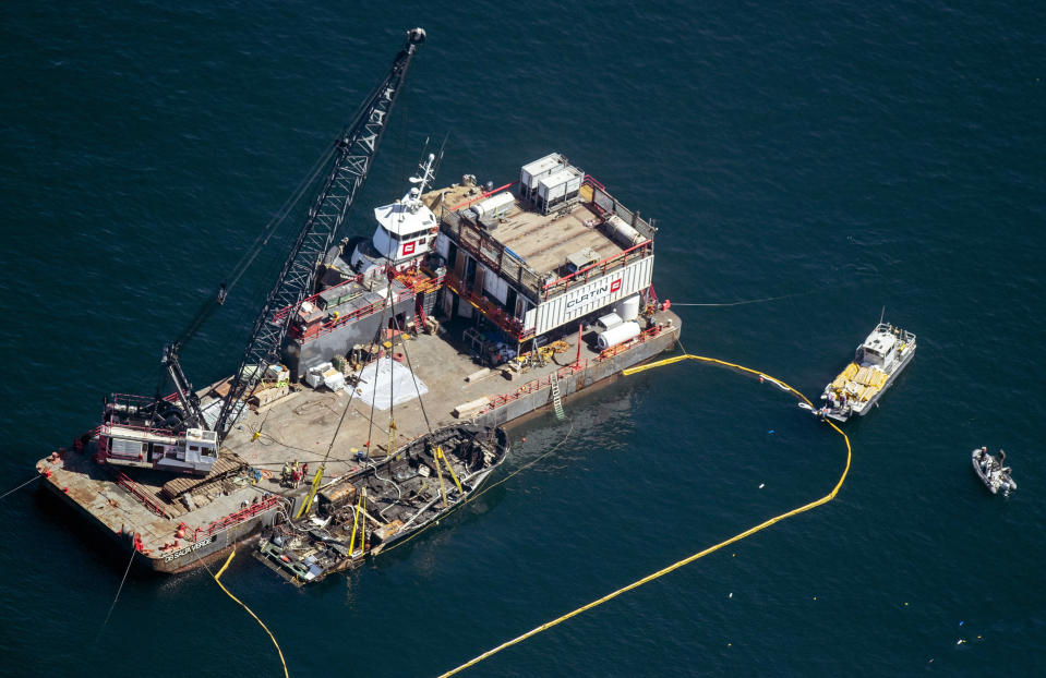 The burned hull of the Conception is brought to the surface by a salvage team, Thursday, Sept. 12, 2019, off Santa Cruz Island, Calif., in the Santa Barbara Channel in Southern California. The vessel burned and sank on Sept. 2, taking the lives of 34 people aboard. Five survived. (Brian van der Brug/Los Angeles Times via AP)