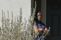 A neighbor reacts near a home where five bodies were found dead, in the city of Lancaster in the high desert Antelope Valley north of Los Angeles, Monday, Nov. 29, 2021. A Los Angeles County Sheriff's Department statement says deputies found a woman, a girl and three boys with gunshot wounds and paramedics pronounced them dead at the scene. The department says the children's father showed up at the Lancaster sheriff's station and was arrested on suspicion of five murders after being interviewed by detectives. (AP Photo/Ringo H.W. Chiu)