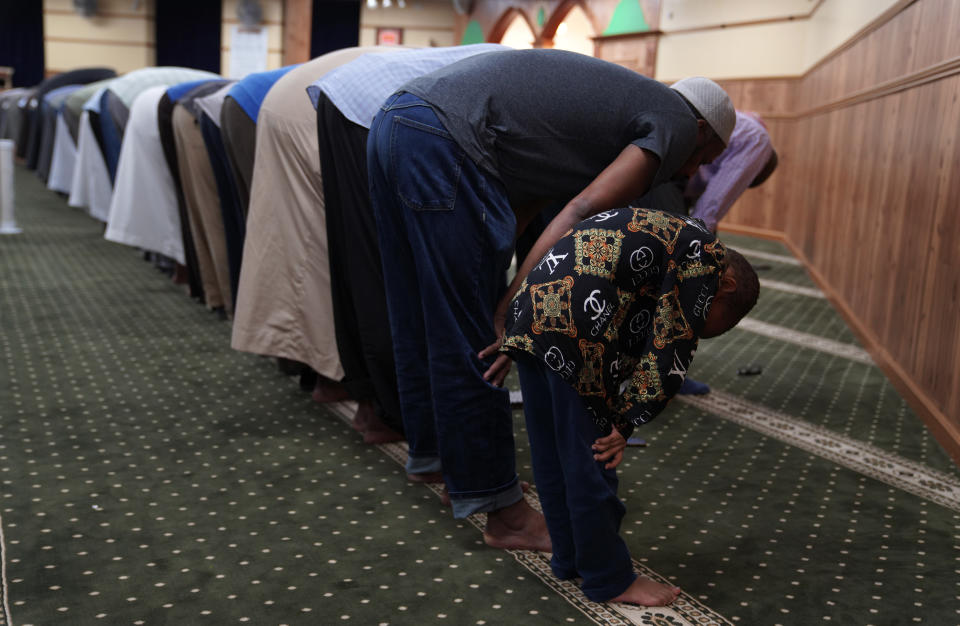 Members of the Abubakar As-Saddique Islamic Center pray in the evening on May 12, 2022, in Minneapolis. This spring Minneapolis became the first large city in the United States to allow the Islamic call to prayer, or adhan, to be broadcast publicly by its two dozen mosques. Abubakar, which hosts some 1,000 men for Friday midday prayers, plans to hold meetings with neighbors before broadcasting this summer. (AP Photo/Jessie Wardarski)