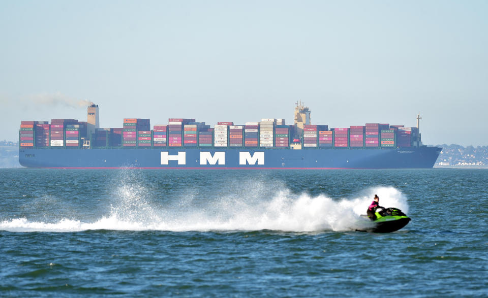 A speedboat in the water looks tiny against the Algeciras.