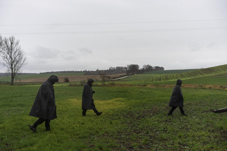 Polish police officers search for missile wreckage in the field, near the place where a missile struck, killing two people in a farmland at the Polish village of Przewodow, near the border with Ukraine, Wednesday, Nov. 16, 2022. (AP Photo/Evgeniy Maloletka)