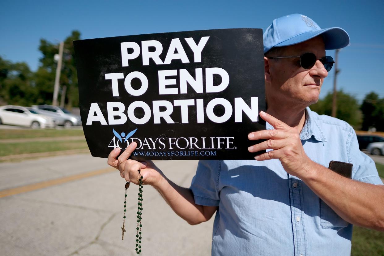 John Bradley holds a sign on Sept. 28, 2022, outside Planned Parenthood in Oklahoma City.