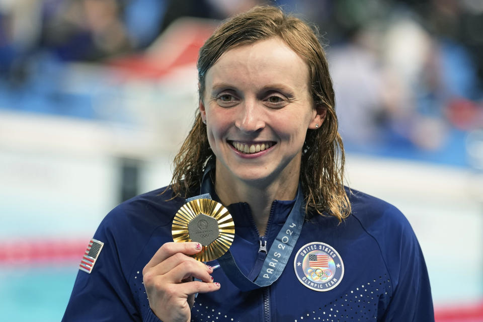 United States' Katie Ledecky celebrates with the gold medal during the awards ceremony for the women's 800-meter freestyle at the Summer Olympics in Nanterre, France, Saturday, Aug. 3, 2024. (AP Photo/Brynn Anderson)