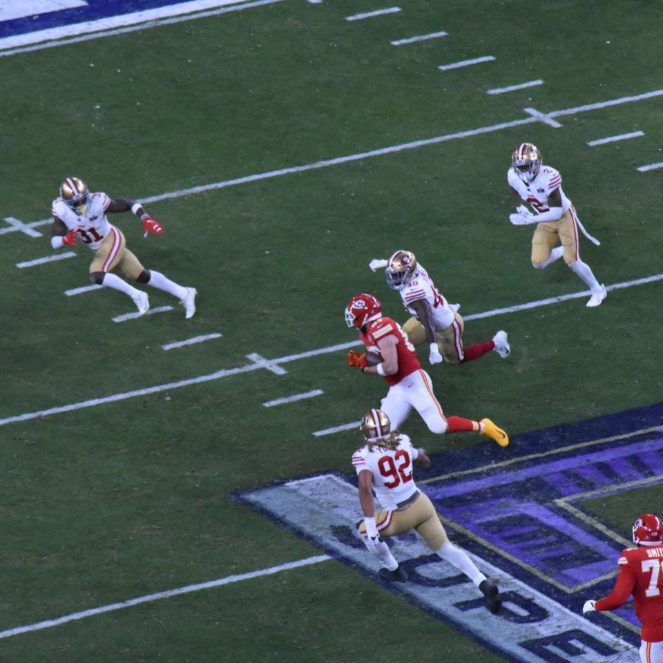 Travis Kelce runs with the ball