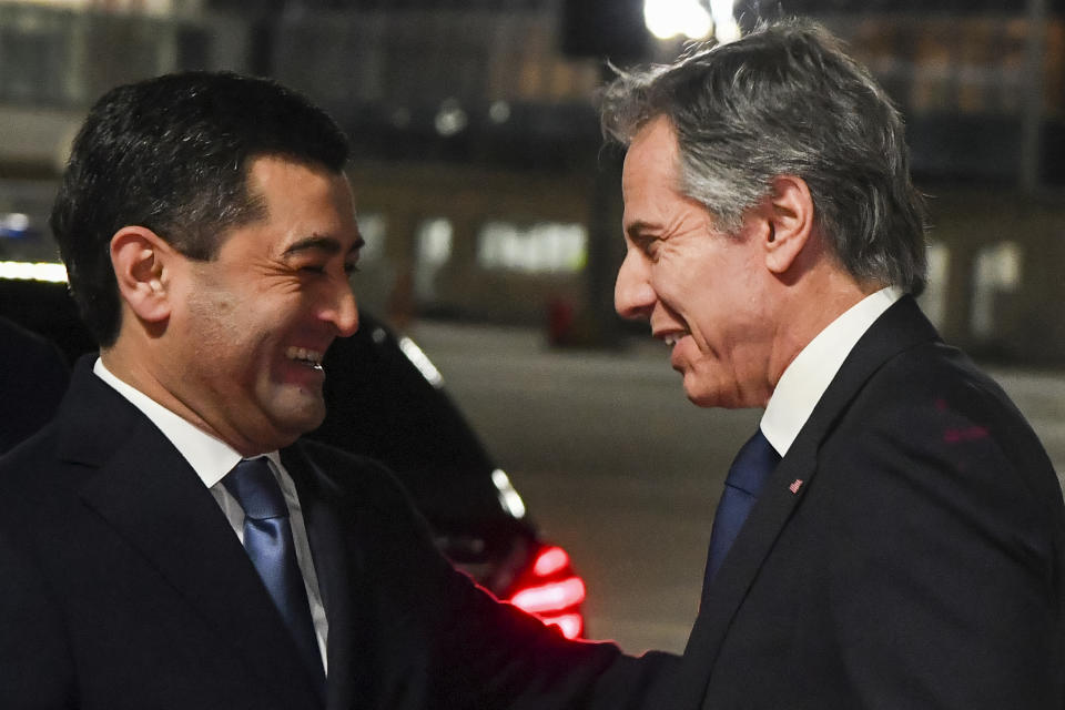 U.S. Secretary of State Antony Blinken, right, smiles as he greets Uzbekistan's acting Foreign Minister Bakhtiyor Saidov upon his arrival in an international airport outside Tashkent, Uzbekistan, Tuesday, Feb. 28, 2023. (AP Photo)