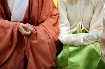 Hai Zhaohang and Zhao Xueqin dressed in "Hanfu" attend a performance of the "guqin" traditional musical instrument in Beijing, China