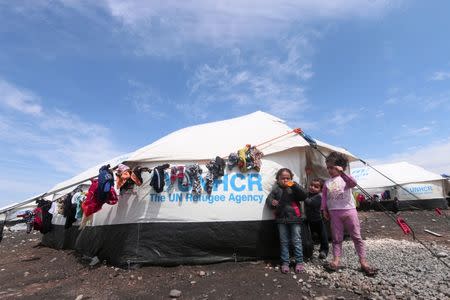 FILE PHOTO: Internally displaced children who fled Raqqa city stand near tents in a camp in Ain Issa, Raqqa Governorate, Syria April 1, 2017. REUTERS/Rodi Said