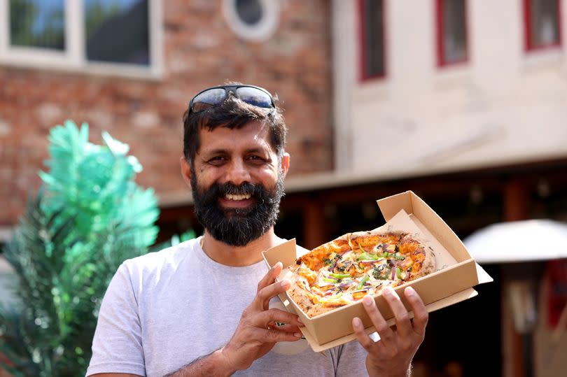 Sud Murugavel with an Indian-inspired pizza at 2 Rowdy's