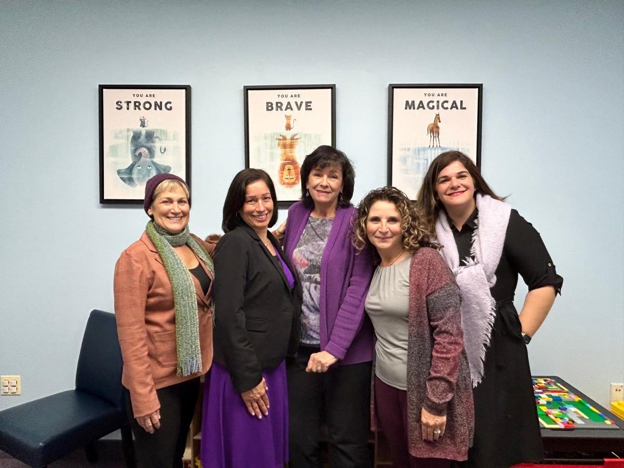 In recognition of Domestic Violence Awareness Month, Women Aware leadership and staff wear purple at the Middlesex County Family Justice Center.