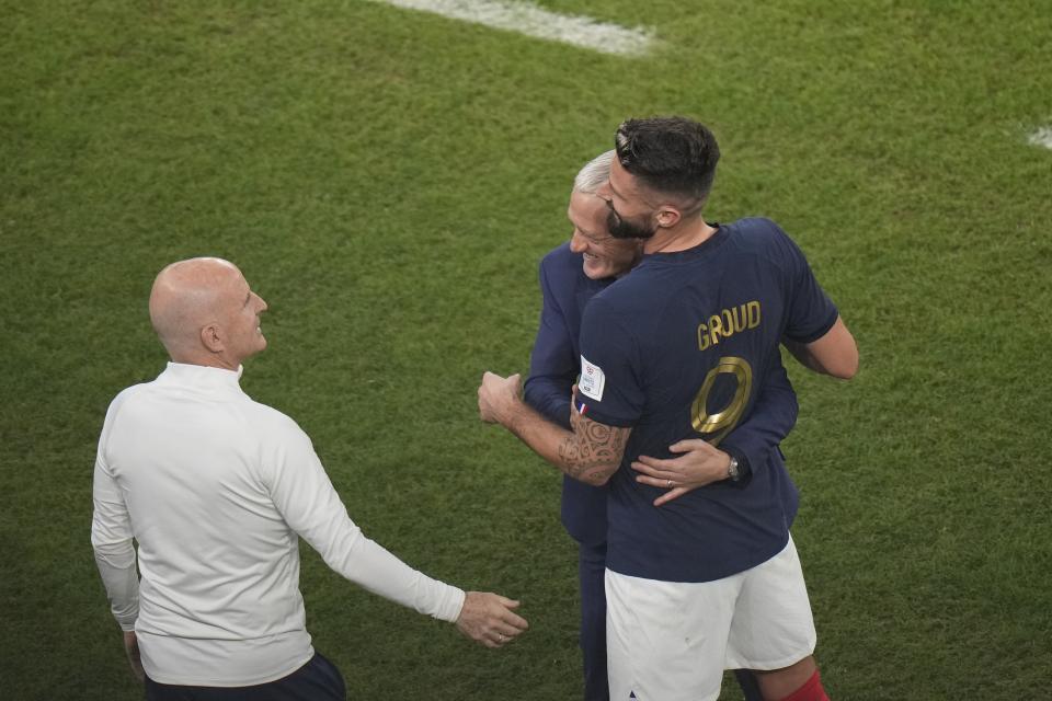 France's head coach Didier Deschamps, center, embraces player Olivier Giroud during the World Cup round of 16 soccer match between France and Poland, at the Al Thumama Stadium in Doha, Qatar, Sunday, Dec. 4, 2022. (AP Photo/Luca Bruno)