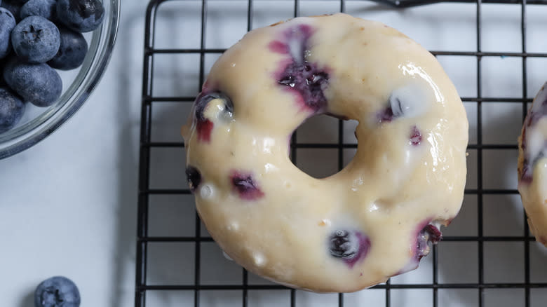 glazed blueberry donut on wire rack