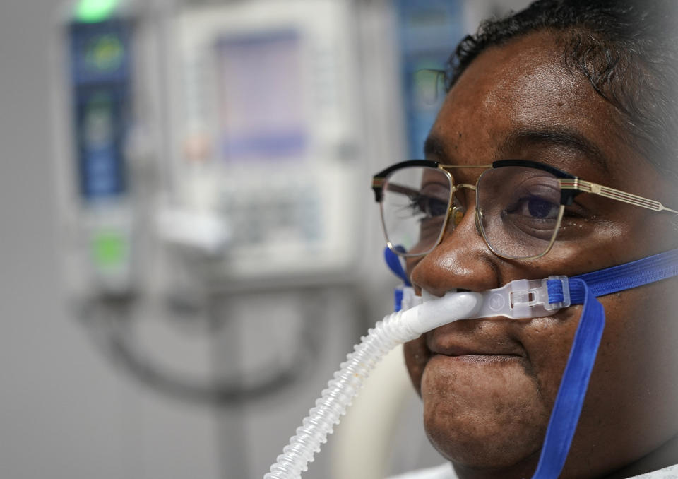 LaTanya Robinson pauses while talking about her ongoing recovery from COVID-19 inside the Coronavirus Unit at United Memorial Medical Center, Monday, July 6, 2020, in Houston. Robinson says she was caring for her son when he got the virus. Both she and her husband eventually caught it. While her son and husband's symptoms were relatively mild, she went from feeling tired and struggling to move to hardly being able to breathe. (AP Photo/David J. Phillip)