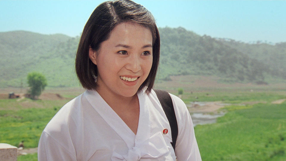 In this image made out of film "Comrade Kim Goes Flying" released by Another Dimension of An Idea/Koryo Group, Comrade Kim Yong Mi played by Han Jong Sim smiles in Korean dress. It's a classic tale of a small town girl who follows her dreams to the big city. But in this case, the girl is a North Korean coal miner, the big city is Pyongyang and her dream is to become a high-flying trapeze artist. “Comrade Kim Goes Flying,” a collaboration between a North Korean director and two European filmmakers, makes its world premiere Saturday, Sept. 8, 2012 at the Toronto International Film Festival before it heads to Pyongyang later this month for its North Korean debut. (AP Photo/Courtesy of Another Dimension of An Idea/Koryo Group) EDITORIAL USE ONLY