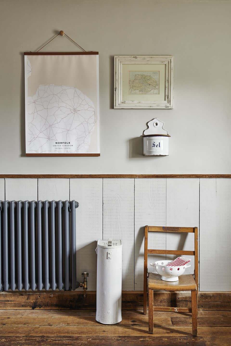 a chair and norfolk maps in a room