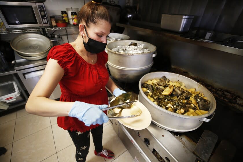 OXNARD, CA - NOVEMBER 30: Griselda Vega displays some of her selection of tamales at Ocho Regiones Restaurant located at 333 Cooper Road in Oxnard which is taking part in the reimagined 14th Annual Oxnard Tamale Festival. The festival has been going on for 14 years, but last year and this year, it&#39;s been limited to just four participants, split up over 4 different days. Ocho Regiones on Tuesday, Nov. 30, 2021 in Oxnard, CA. (Al Seib / Los Angeles Times).