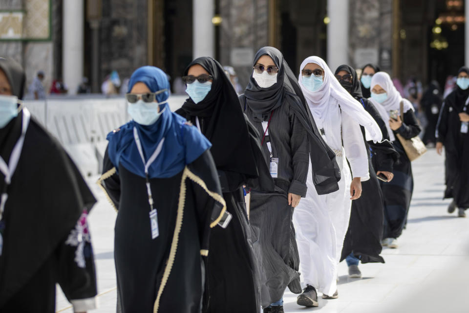 In this photo released by the Saudi Media Ministry, a limited numbers of pilgrims move several feet apart, circling the cube-shaped Kaaba in the first rituals of the hajj, as they keep social distancing to limit exposure and the potential transmission of the coronavirus, at the Grand Mosque in the Muslim holy city of Mecca, Saudi Arabia, Wednesday, July 29, 2020. The hajj, which started on Wednesday, is intended to bring about greater humility and unity among Muslims. (Saudi Media Ministry via AP)