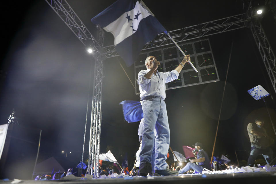 National Party presidential candidate Nasry Asfura waves a flag during a closing campaign rally, in Tegucigalpa, Honduras, Sunday, Nov. 21, 2021. Honduras will hold its presidential election on Nov. 28. (AP Photo/Elmer Martinez)