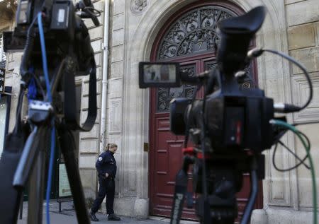 A police officer stands guard at the entrance of a luxury residence on the Rue Tronchet in central Paris, France, October 3, 2016 where masked men robbed U.S. reality TV star Kim Kardashian West at gunpoint early on Monday, stealing jewellery worth millions of dollars, police and her publicist said. REUTERS/Gonzalo Fuentes