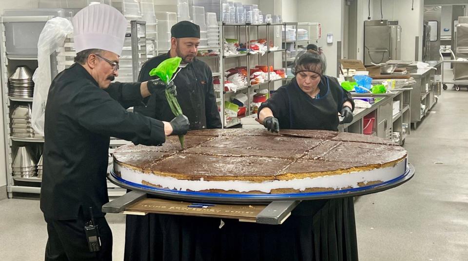Irving Convention Center Executive Chef Eduardo Alvarez, Maria Mora and Angel Parra complete a test run of making the "world's largest" moon pie.