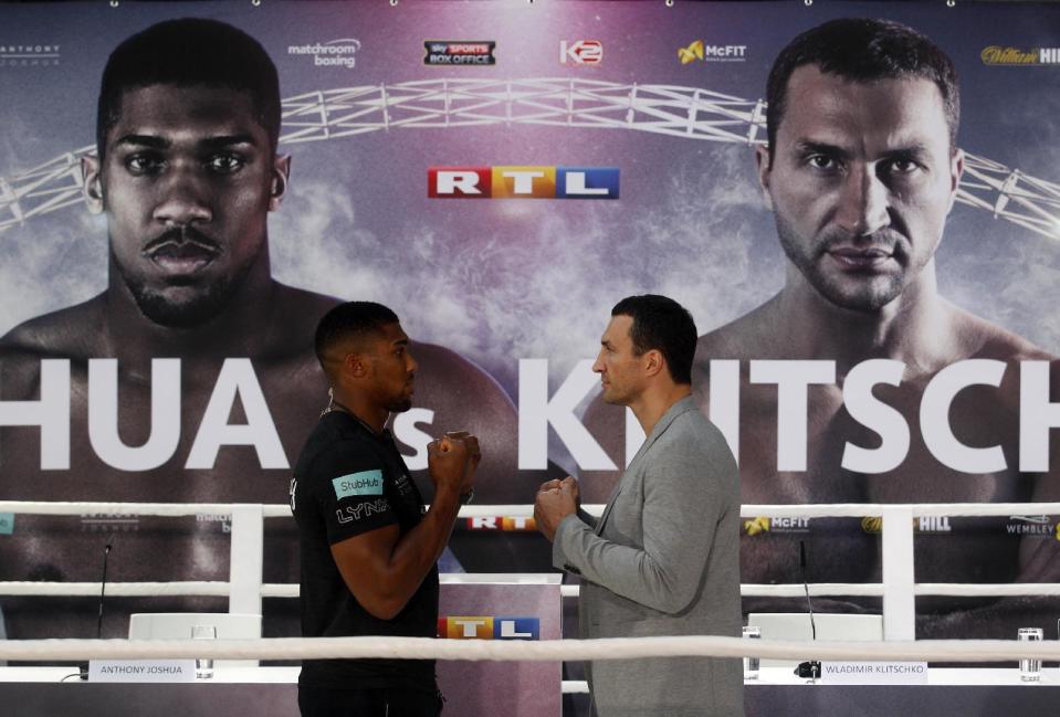 Ukrainian boxer Wladimir Klitschko, right, and Britain's Anthony Joshua face each other during a press conference in Cologne, western Germany, Thursday, Feb. 16, 2017. Klitschko and Joshua will fight for the IBF title in London on April 29. (Roland Weihrauch/dpa via AP)