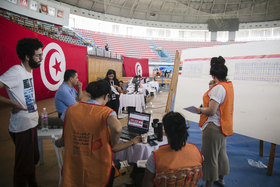 Members of the Independent Higher Authority for Elections count the votes one day after the constitutional referendum in Tunis. Tuesday, July 26, 2022. Tunisians awaited Tuesday for the official preliminary results of a constitutional referendum held a day earlier. The proposed constitution gives the office of the president all executive powers and removes key checks and balances. (AP Photo/Hassene Dridi)