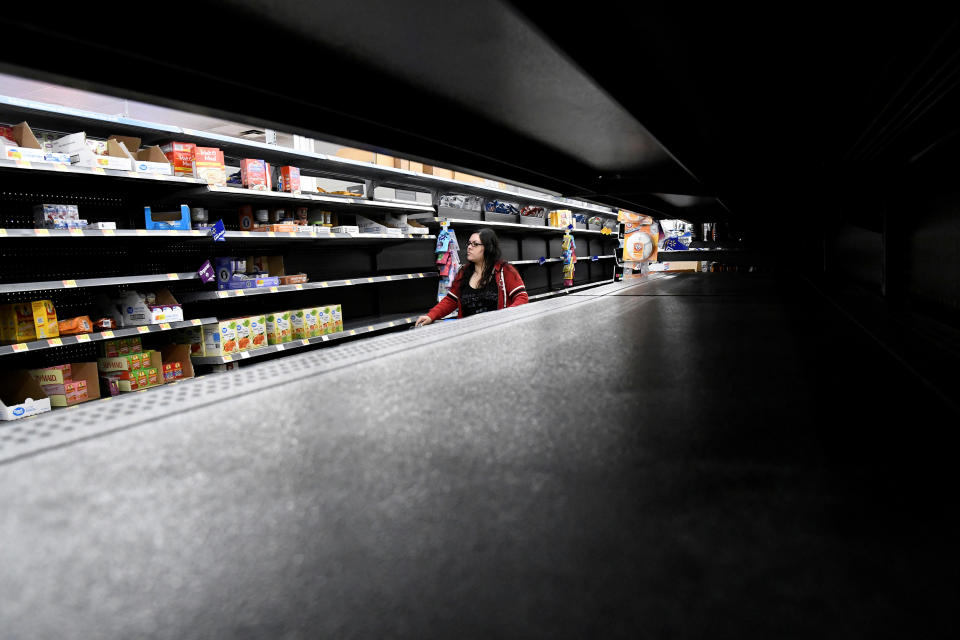 <p>Nina Roberts shops for last minute supplies while shelves remain empty as Hurricane Lane approaches Honolulu, Hawaii, Aug. 23, 2018. (Photo: Hugh Gentry/Reuters) </p>