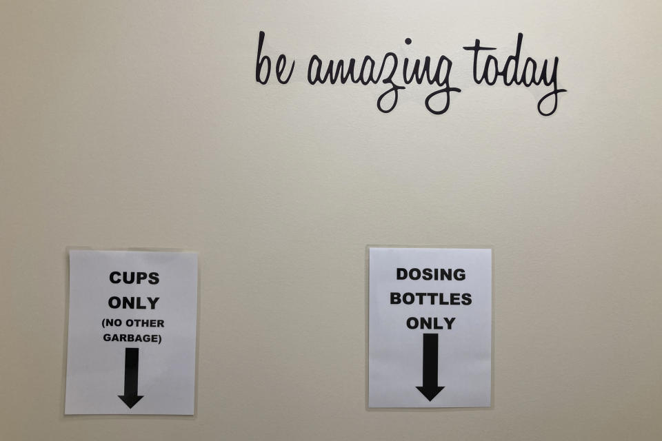 Signs at the Great Circle treatment center show where receptacles used to dispense methadone should be disposed of after use in Salem, Oregon, on Feb. 24, 2022. The center gets funding from Oregon's pioneering drug decriminalization law and illustrates an aspect of the new system, one year after it took effect. (AP Photo/Andrew Selsky)