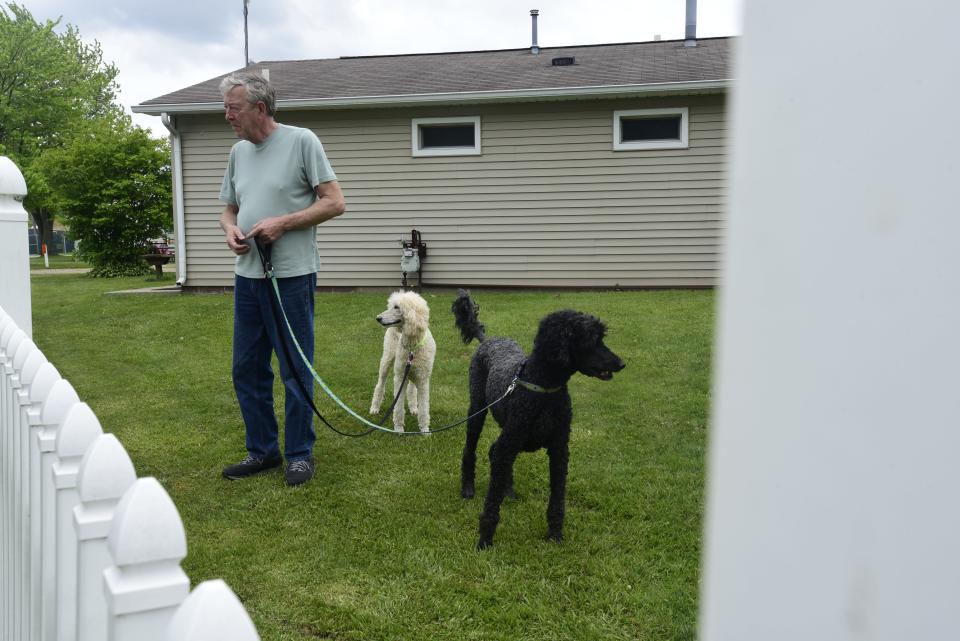 Dale Newell, of Sequim, Washington., walks his two dogs around the premises of the Port Huron Township RV Park on Water Street Thursday, May 26, 2022. He and his wife, who's from Port Huron, arrived with in their camper Tuesday. The township park has been a regular stop for the couple for six years.