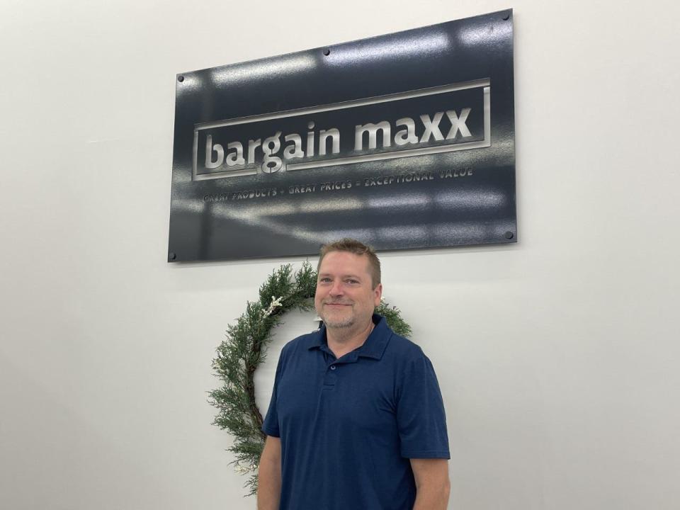 Marty Allen, co-owner of Bargain Maxx, poses on July 12, 2022, in Freeport.