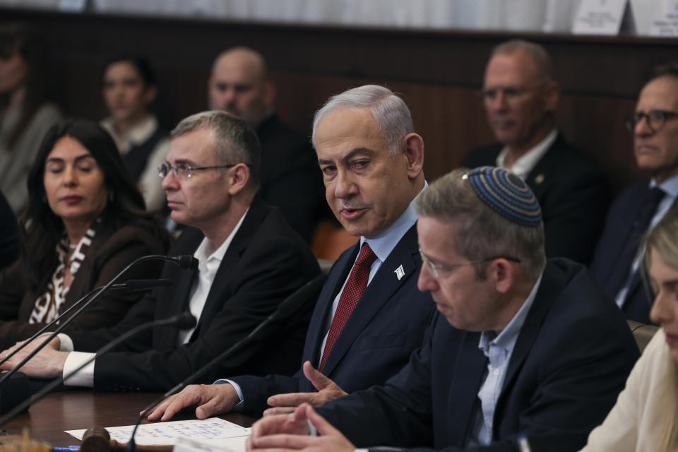 Israeli Prime Minister Benjamin Netanyahu, center, attends the weekly cabinet meeting at the Prime Minister's office in Jerusalem, Sunday, Dec. 10, 2023. (Ronen Zvulun/Pool Photo via AP)