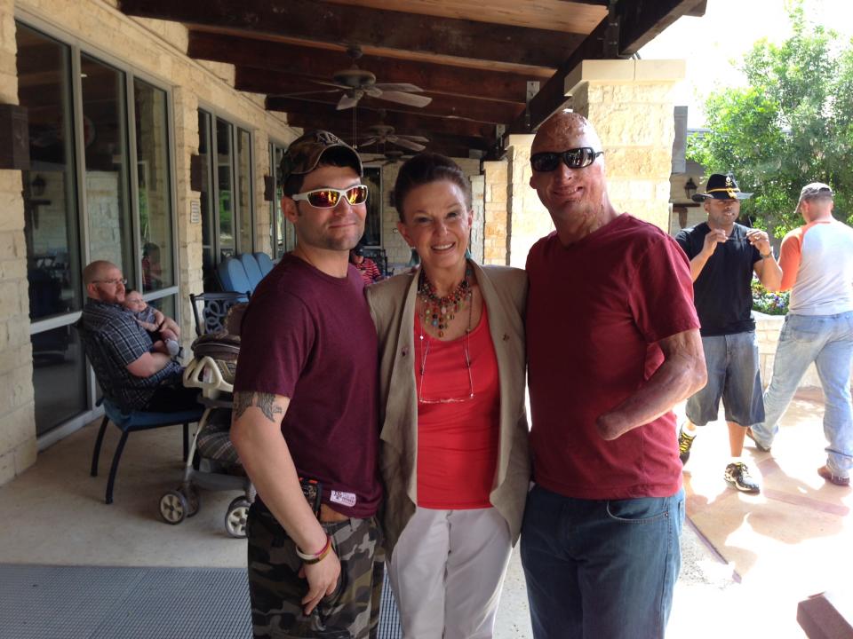 Maggie Lockridge poses with two veterans. Her foundation, Rebuilding America's Warriors, pairs wounded vets with plastic surgeons to repair their injuries in the most aesthetically pleasing way.