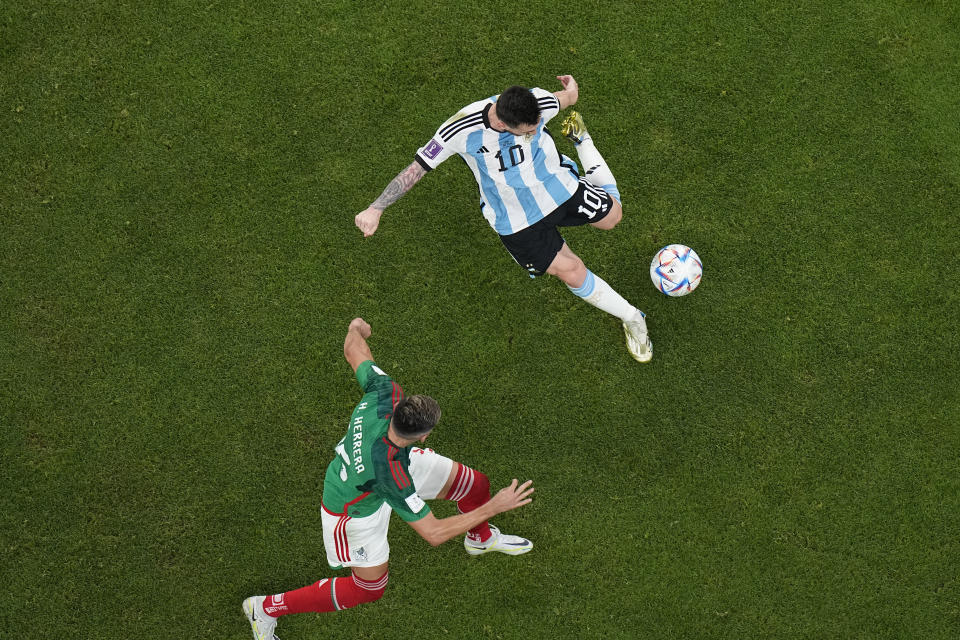 Argentina's Lionel Messi scores his side's opening goal during the World Cup group C soccer match between Argentina and Mexico, at the Lusail Stadium in Lusail, Qatar, Saturday, Nov. 26, 2022. (AP Photo/Pavel Golovkin)