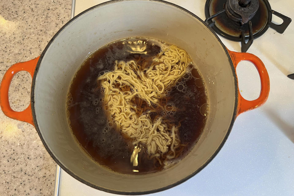 A ramen noodled is added to the soup being cooked in Tokyo, on April 22, 2024. Ramen noodles are so popular they have become one reason to visit Japan. But ramen can easily be cooked at home too, especially if you can find the ingredients at your neighborhood Asian grocery store. (AP Photo/Yuri Kageyama)