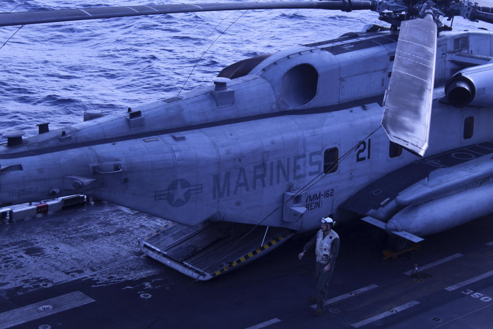 A maintainer inspects a CH53 Sea Stallion heavy lift helicopter assigned to the 26th Marine Expeditionary Unit on the USS Bataan in the Aegean Sea, Greece, Friday, Jan. 19, 2024. The Bataan, an amphibious assault ship, is leading a U.S. Navy task force in the eastern Mediterranean as the United States maintains an increased level of military deployment in the Middle East. (AP Photo/Derek Gatopoulos)