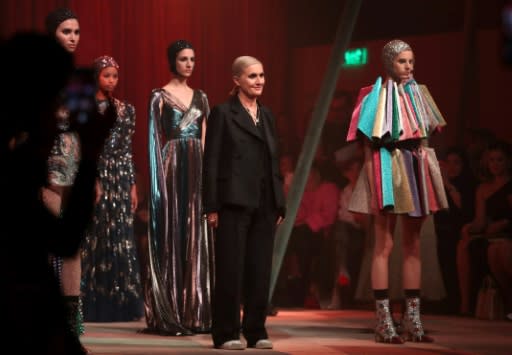 Italian fashion designer Maria Grazia Chiuri (C) acknowledges the audience at the end of the Christian Dior Haute Couture Spring-Summer 2019 collection fashion show in the United Arab Emirate of Dubai on March 18, 2019