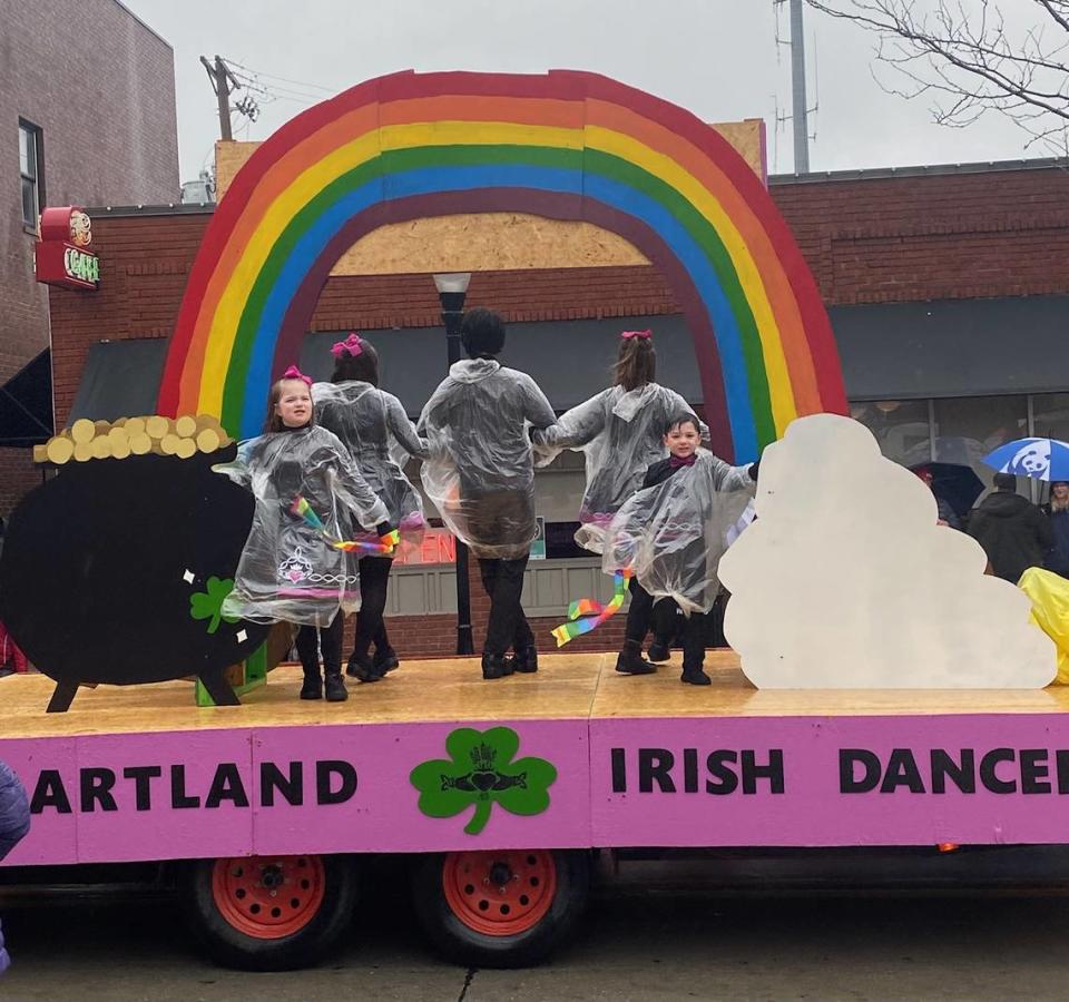 Soggy young dancers perform on a float during the Emerald Isle Parde March 11.