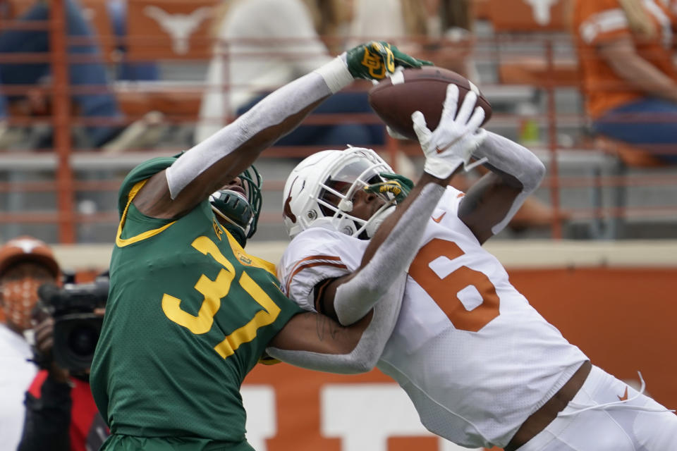 Baylor's Mark Milton (37) knocks the ball away from Texas' Joshua Moore (6) during the first half of an NCAA college football game in Austin, Texas, Saturday, Oct. 24, 2020. (AP Photo/Chuck Burton)