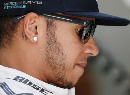 Mercedes Formula One Driver Lewis Hamilton of Britain checks his car at the pit-lane during the third free practice ahead of Bahrain's F1 Grand Prix at Bahrain International Circuit, south of Manama April 18, 2015. REUTERS/Ahmed Jadallah