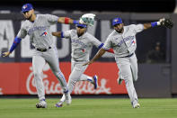 Toronto Blue Jays left fielder Lourdes Gurriel Jr., left, Teoscar Hernandez and Jackie Bradley Jr., right, celebrate after the ninth inning of the team's baseball game against the New York Yankees on Friday, Aug. 19, 2022, in New York. The Blue Jays won 4-0. (AP Photo/Adam Hunger)