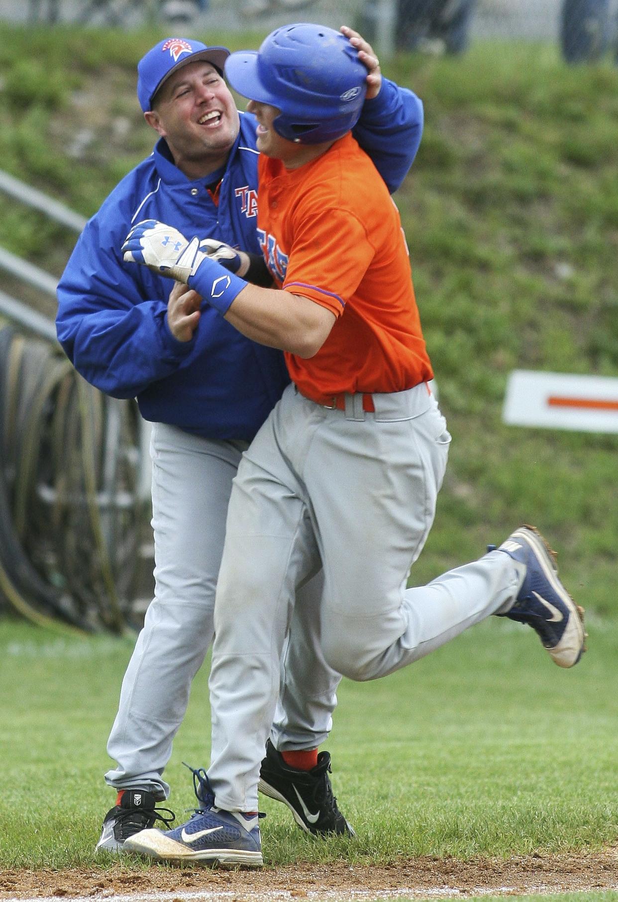 Edison's Zac Bellinger is congratulated by head coach Mike Bennett as he rounds third base after hitting a grand slam against Tioga in 2011.