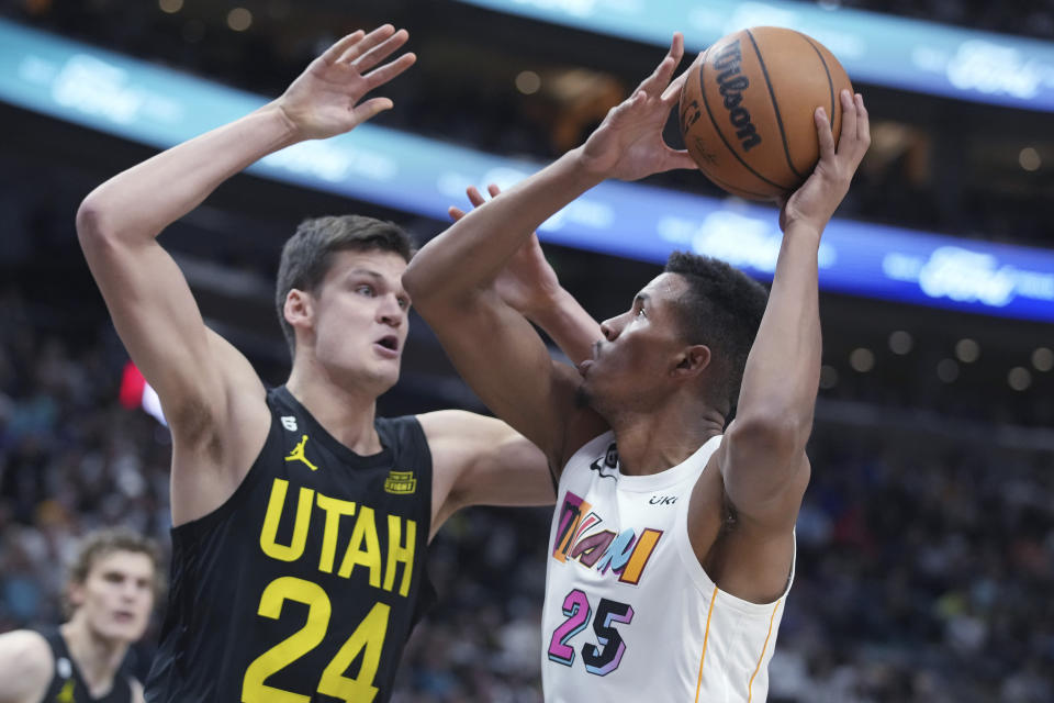 Miami Heat center Orlando Robinson (25) looks to shoot over Utah Jazz center Walker Kessler (24) during the first half of an NBA basketball game Saturday, Dec. 31, 2022, in Salt Lake City. (AP Photo/George Frey)