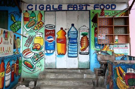 A mural on the wall of a fast food store illustrates food and drinks in Wabari district of Mogadishu, Somalia, June 8, 2017. REUTERS/Feisal Omar SEARCH "OMAR SHOPS" FOR THIS STORY. SEARCH "WIDER IMAGE" FOR ALL STORIES.