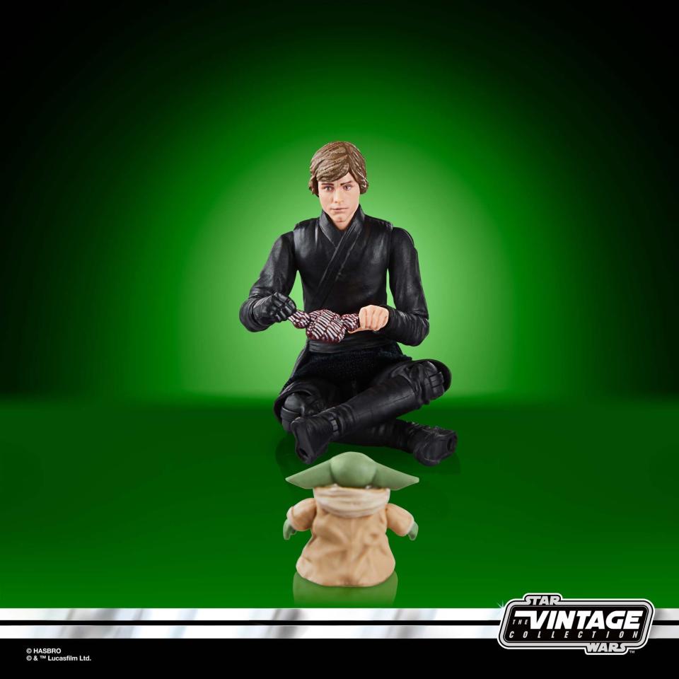 Star Wars Luke and Grogu action figures posed against a green background