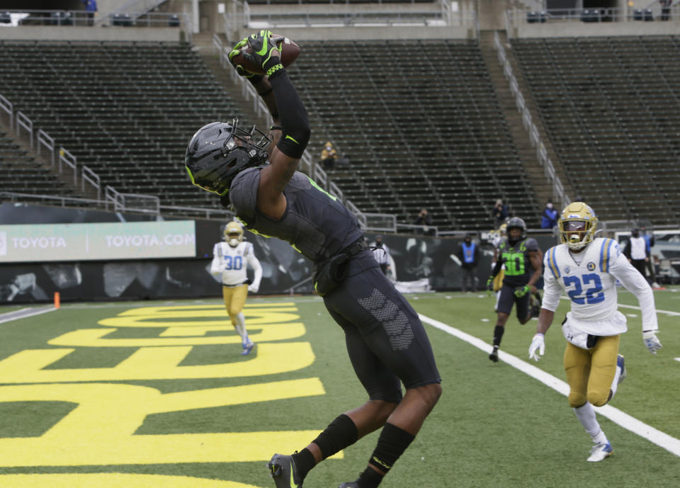 Oregon's Devon Williams pulls down in a Tyler Shough pass for a touchdown against UCLA during the first quarter of an NCAA college football game Saturday, Nov. 21, 2020, in Eugene, Ore. (AP Photo/Chris Pietsch)