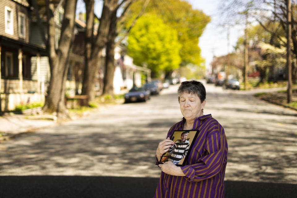 Georgene White stands for a portrait with a photo of her mother, Teri Sheridan, in Belvidere, N.J., Thursday, April 20, 2023. At age 93, struggling with the effects of a stroke, heart failure and recurrent cancer, Sheridan was ready to end her life using New Jersey's law that allows medically assisted suicide - but she was bedbound, too sick to travel. So on Nov. 17, 2022, surrounded by three of her children, Sheridan drank a lethal dose of drugs prescribed by a doctor she had never met in person, only online. She died within minutes. (AP Photo/Matt Rourke)